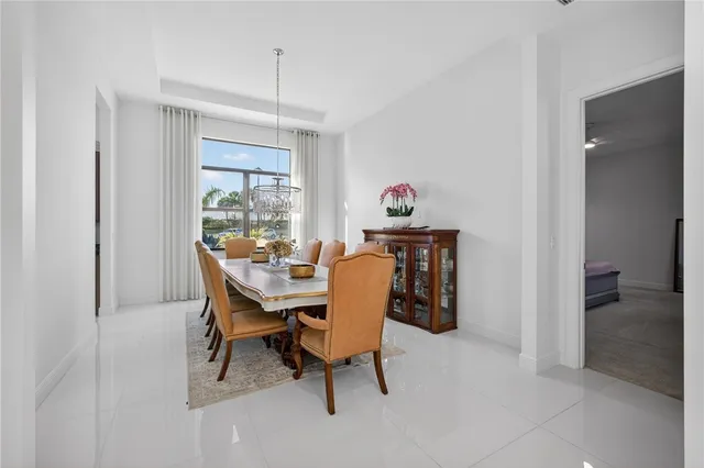 a view of a dining room with furniture and a chandelier
