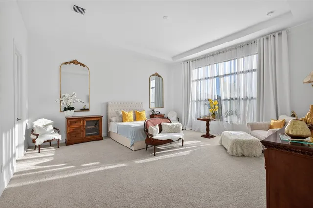 a bedroom with furniture and a mirror