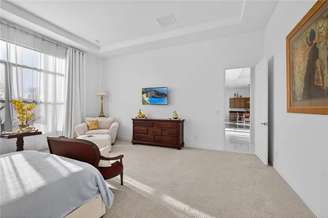 a bedroom with a bed couch and window