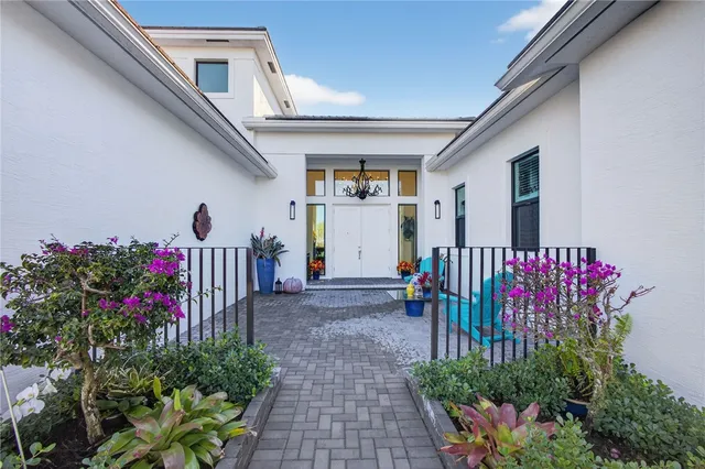 a front view of a house with a flower garden
