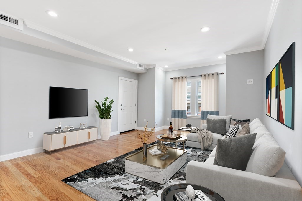 9 Wales Street, Unit 2 Boston, MA 02124 - Photo 2 of 15 a living room with furniture a flat screen tv and a large window