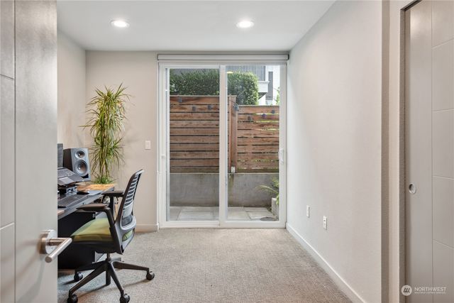 a livingroom with furniture and a potted plant