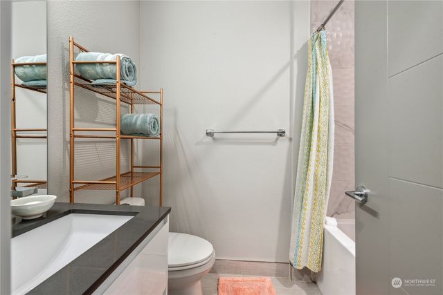 a bathroom with a toilet a sink and shower