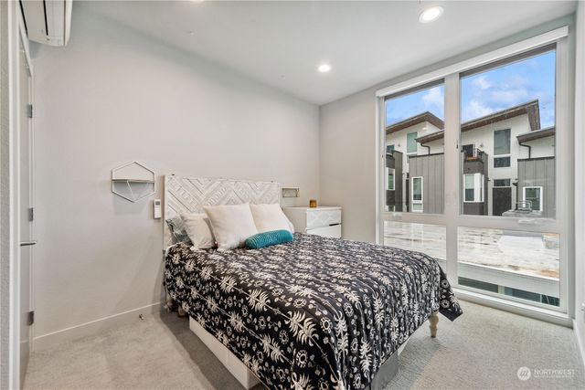 a large bed sitting in a bedroom next to a window
