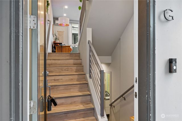 a view of staircase with lots of frames and chairs