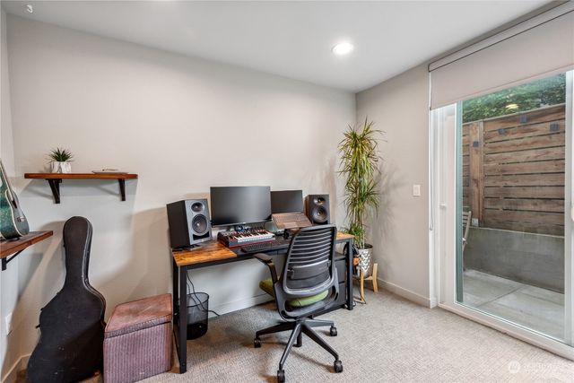 a view of a workspace with furniture and a window