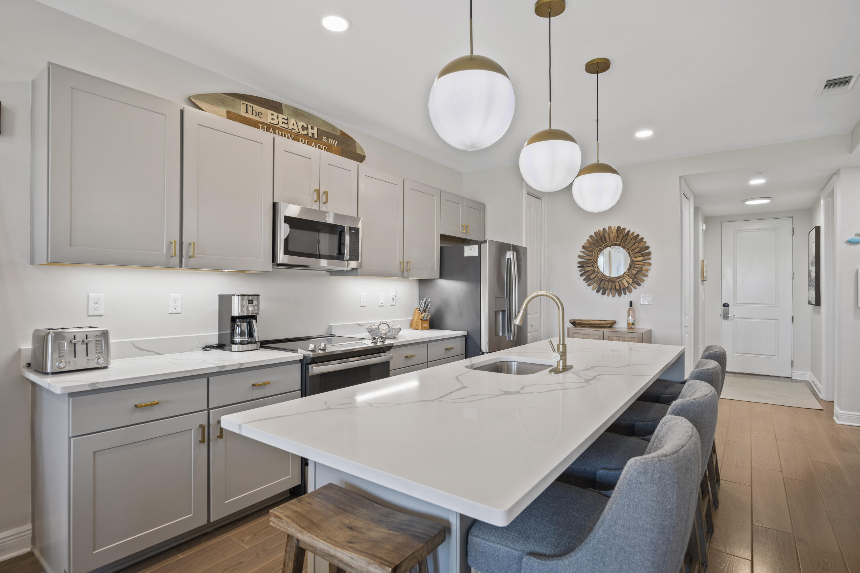 1740 South County Highway, Unit 203 Santa Rosa Beach, FL 32459 - Photo 1 of 40 a kitchen with a table chairs sink and cabinets