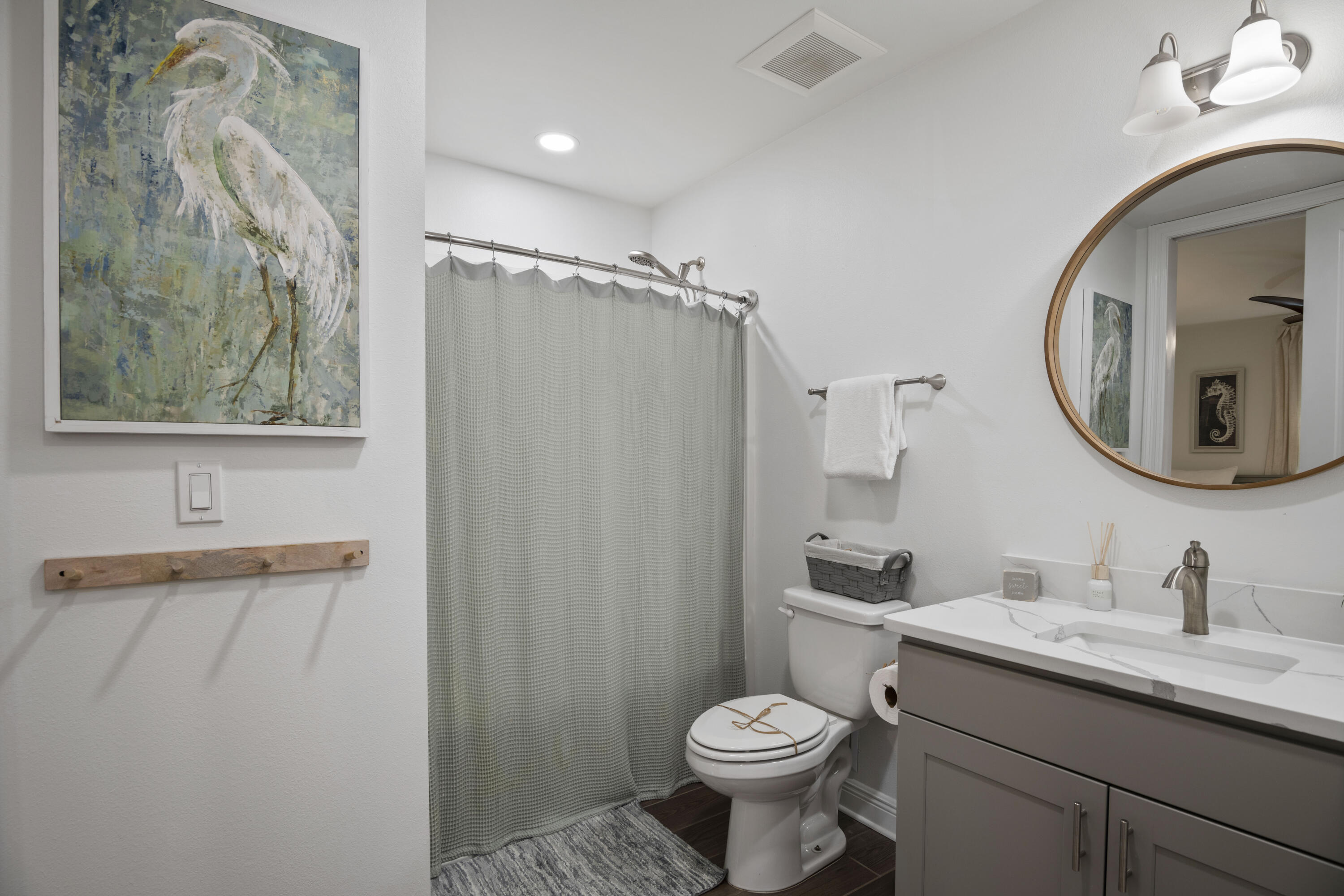 1740 South County Highway, Unit 203 Santa Rosa Beach, FL 32459 - Photo 16 of 40 a bathroom with a toilet sink vanity granite and mirror