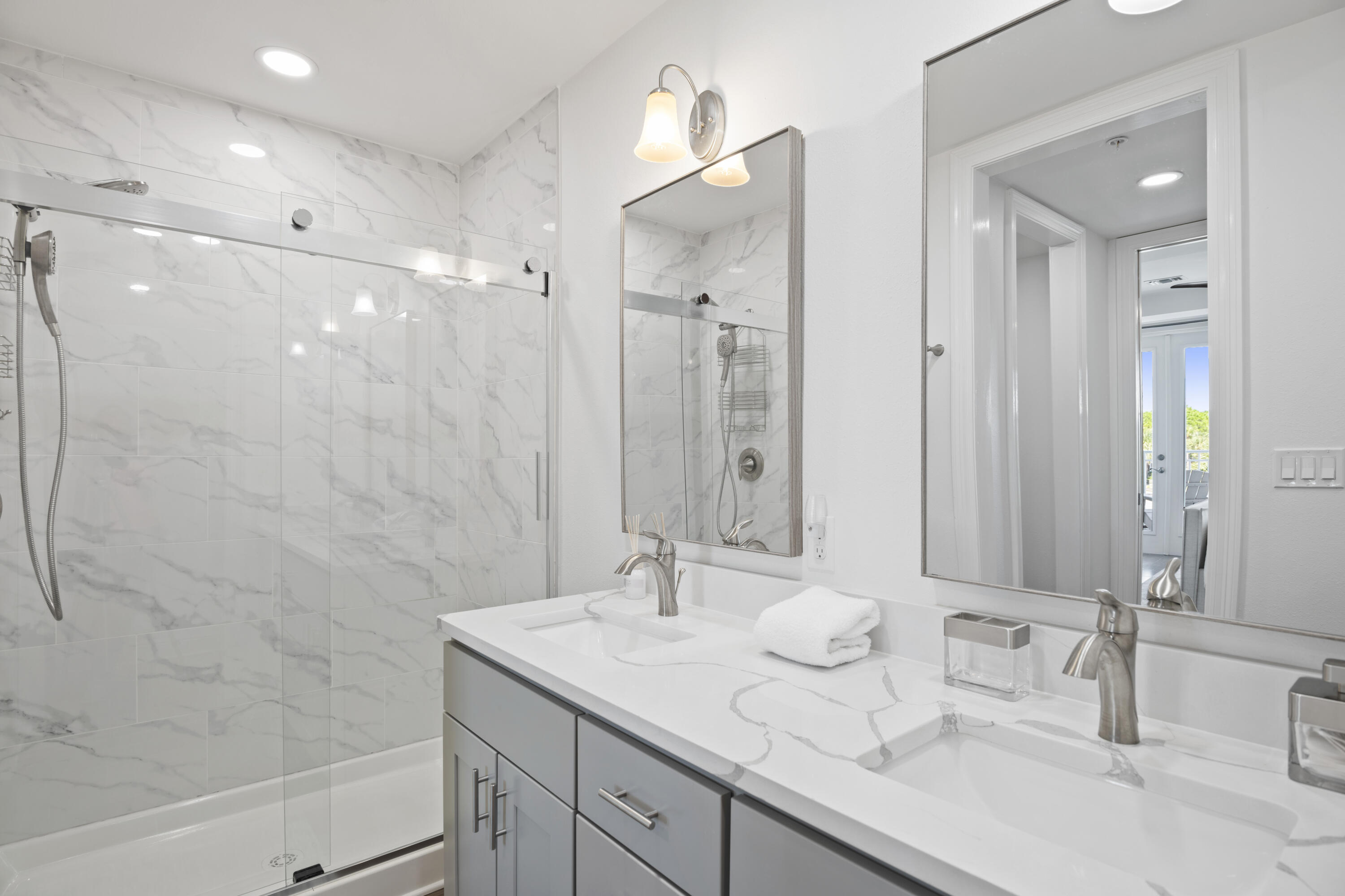 1740 South County Highway, Unit 203 Santa Rosa Beach, FL 32459 - Photo 20 of 40 a bathroom with a double vanity sink mirror and shower