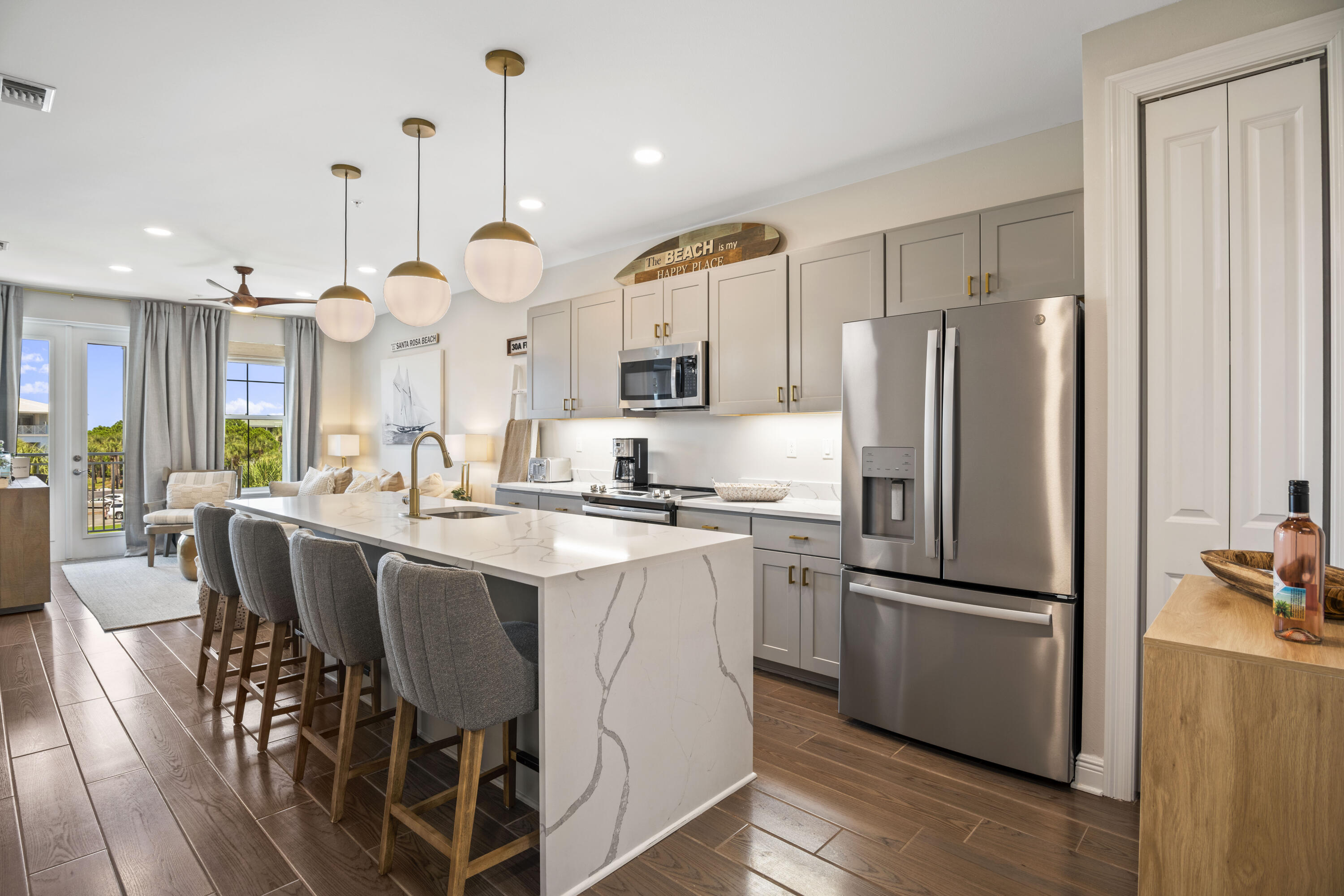 1740 South County Highway, Unit 203 Santa Rosa Beach, FL 32459 - Photo 2 of 40 a kitchen with stainless steel appliances granite countertop a refrigerator a sink dishwasher a dining table and chairs with wooden floor
