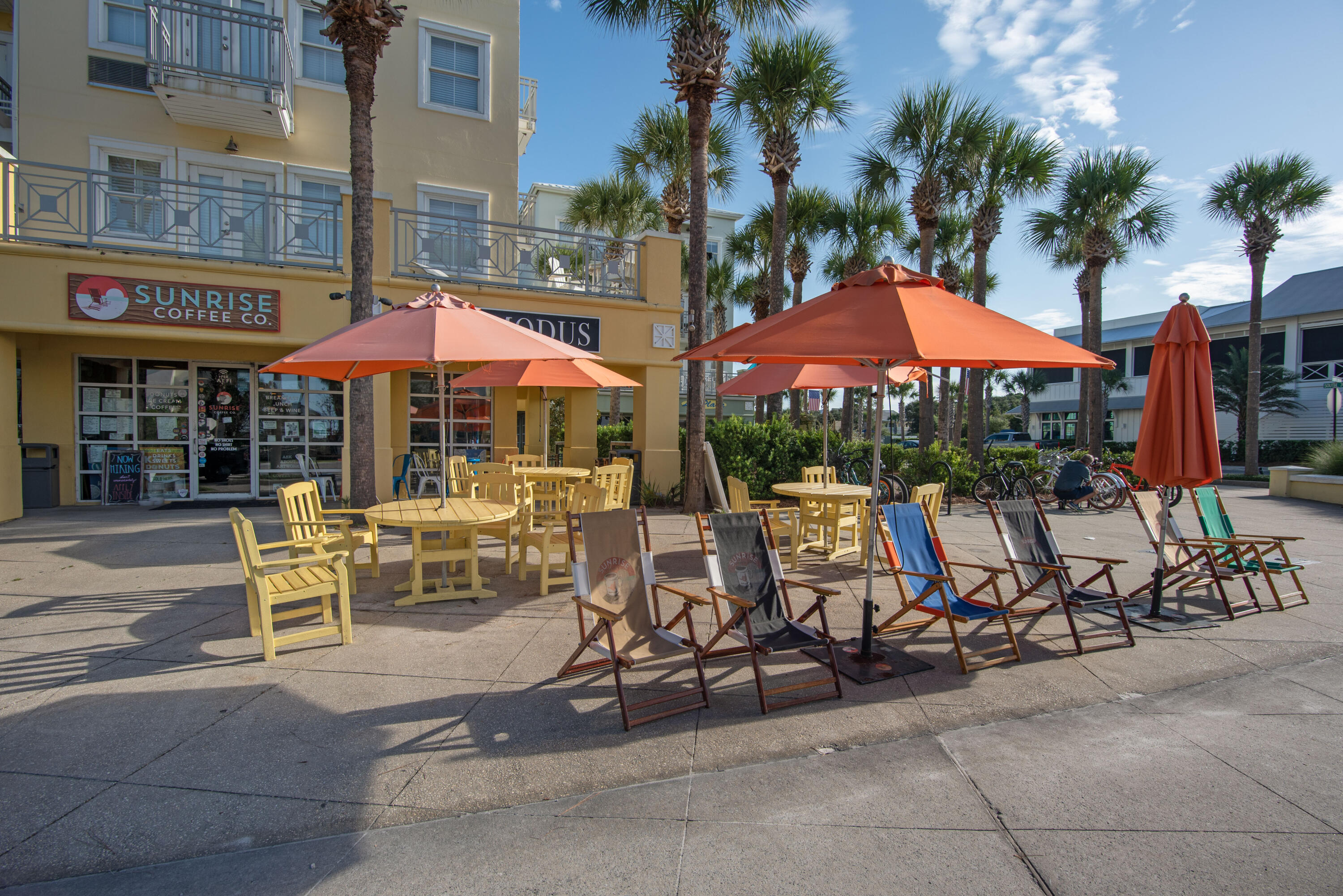 1740 South County Highway, Unit 203 Santa Rosa Beach, FL 32459 - Photo 35 of 40 a view of a cafe with tables and chairs under an umbrella