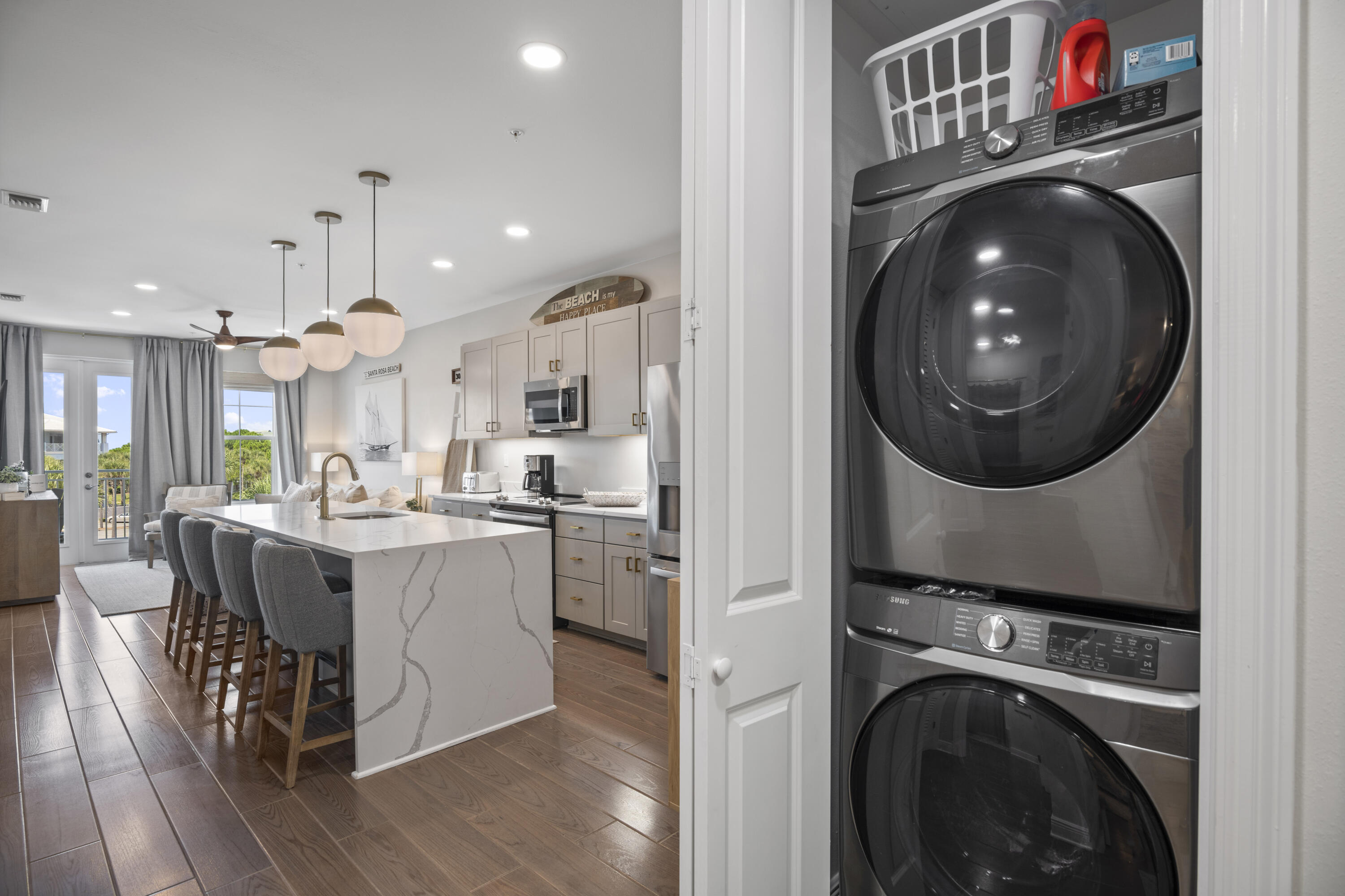 1740 South County Highway, Unit 203 Santa Rosa Beach, FL 32459 - Photo 9 of 40 a kitchen with kitchen island a white stove a sink and a refrigerator with wooden floor