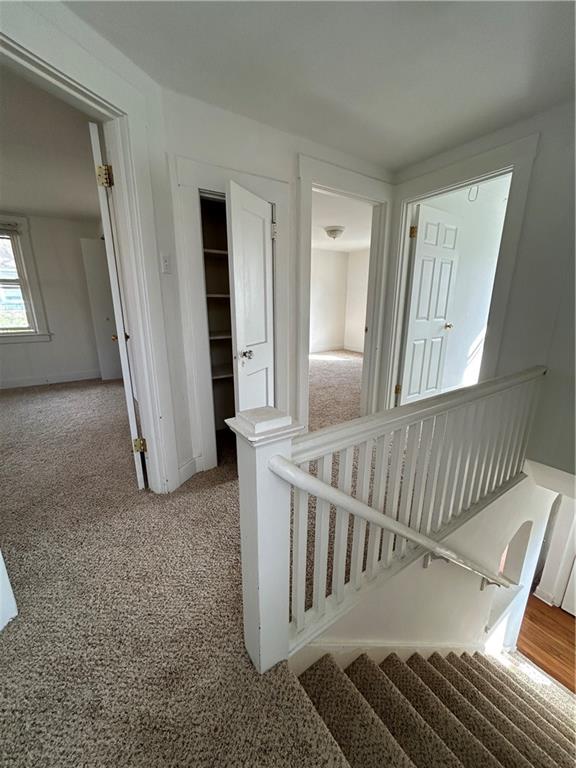 1317 Old Freeport Road Pittsburgh, PA 15238 - Photo 15 of 38 a view of an empty room with wooden floor and stairs