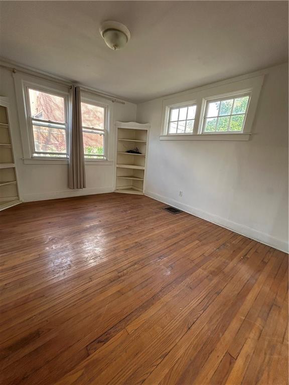 1317 Old Freeport Road Pittsburgh, PA 15238 - Photo 16 of 49 an empty room with wooden floor and windows