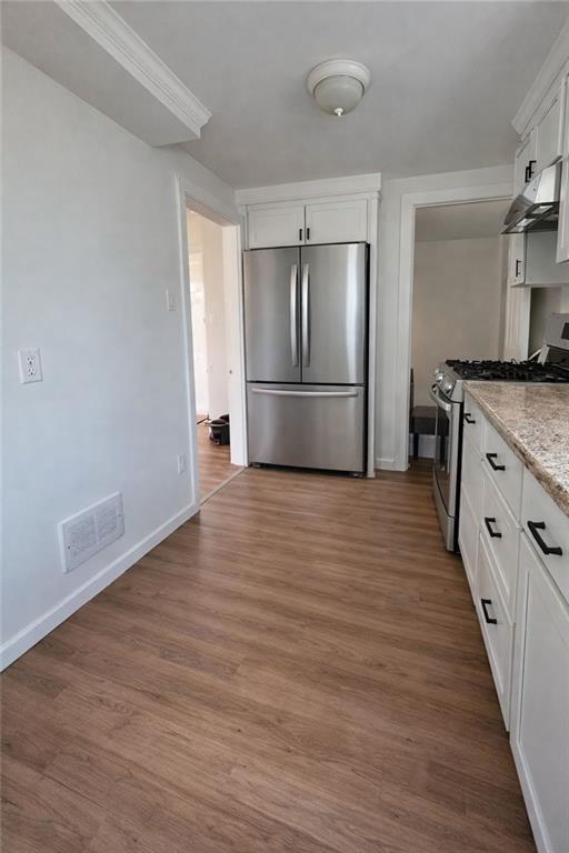 1317 Old Freeport Road Pittsburgh, PA 15238 - Photo 19 of 49 a kitchen with stainless steel appliances granite countertop a refrigerator a stove and a wooden floors