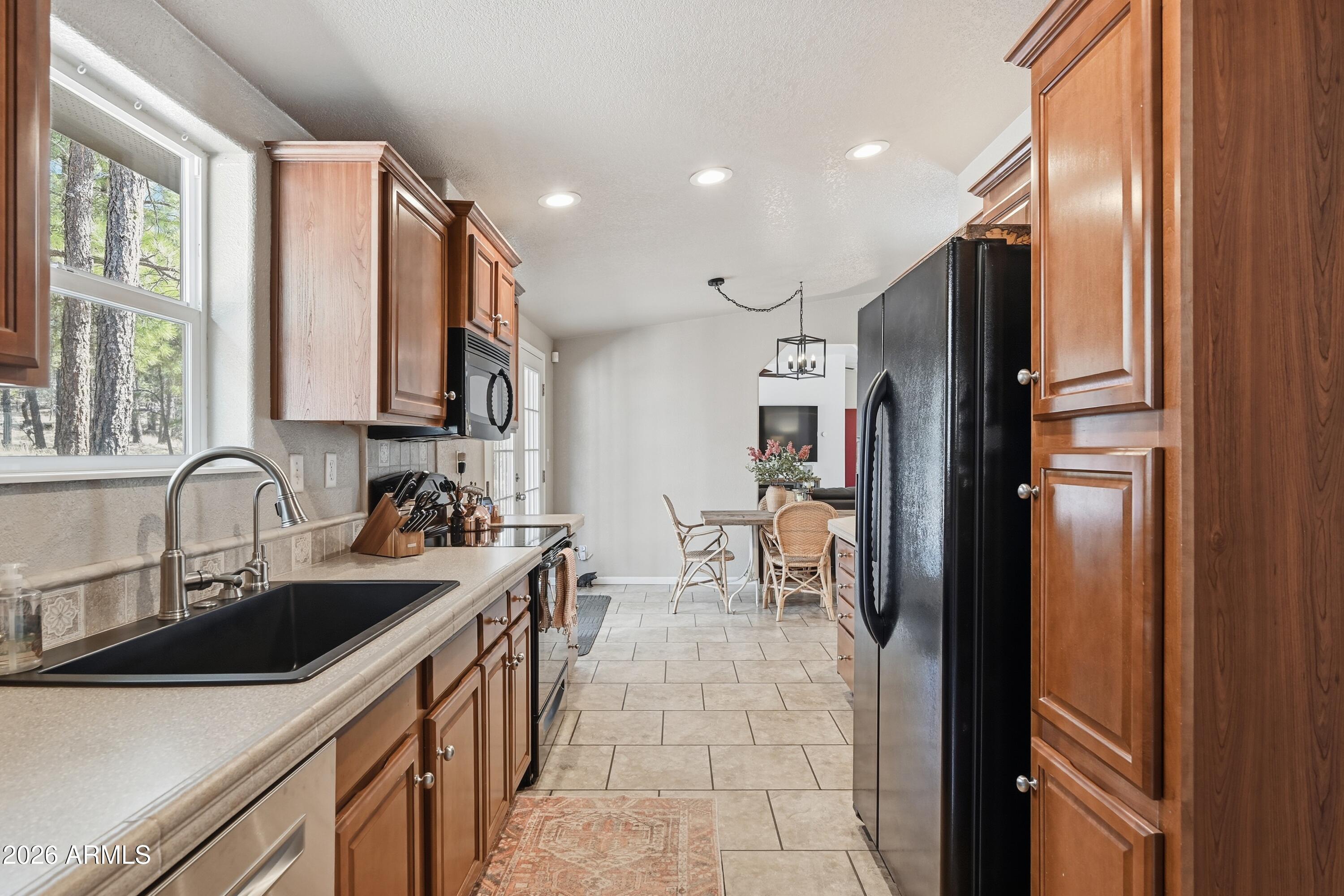 2381 Blue Ridge Drive Happy Jack, AZ 86024 - Photo 15 of 45 a kitchen with stainless steel appliances a sink stove and refrigerator