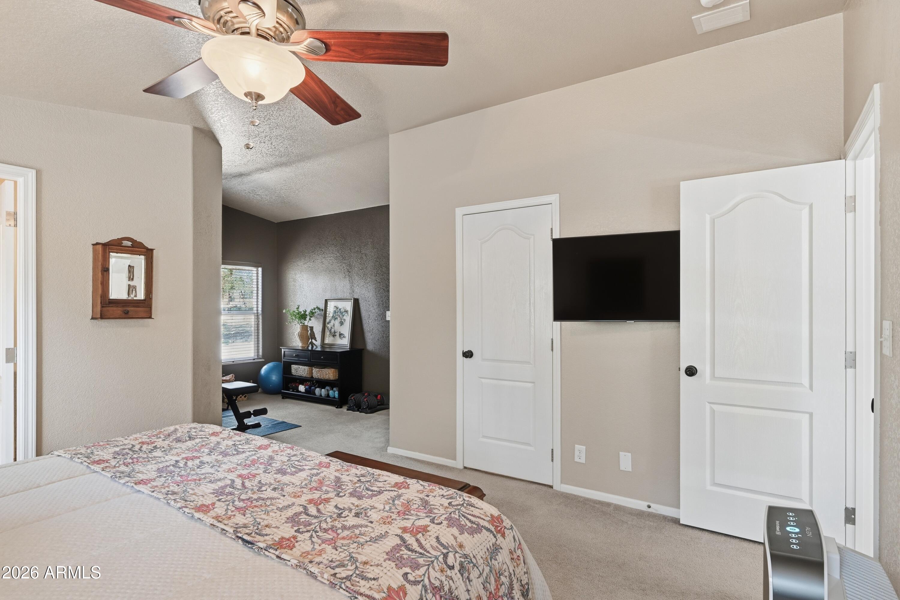 2381 Blue Ridge Drive Happy Jack, AZ 86024 - Photo 17 of 45 a bedroom with a bed and a flat tv screen on wall