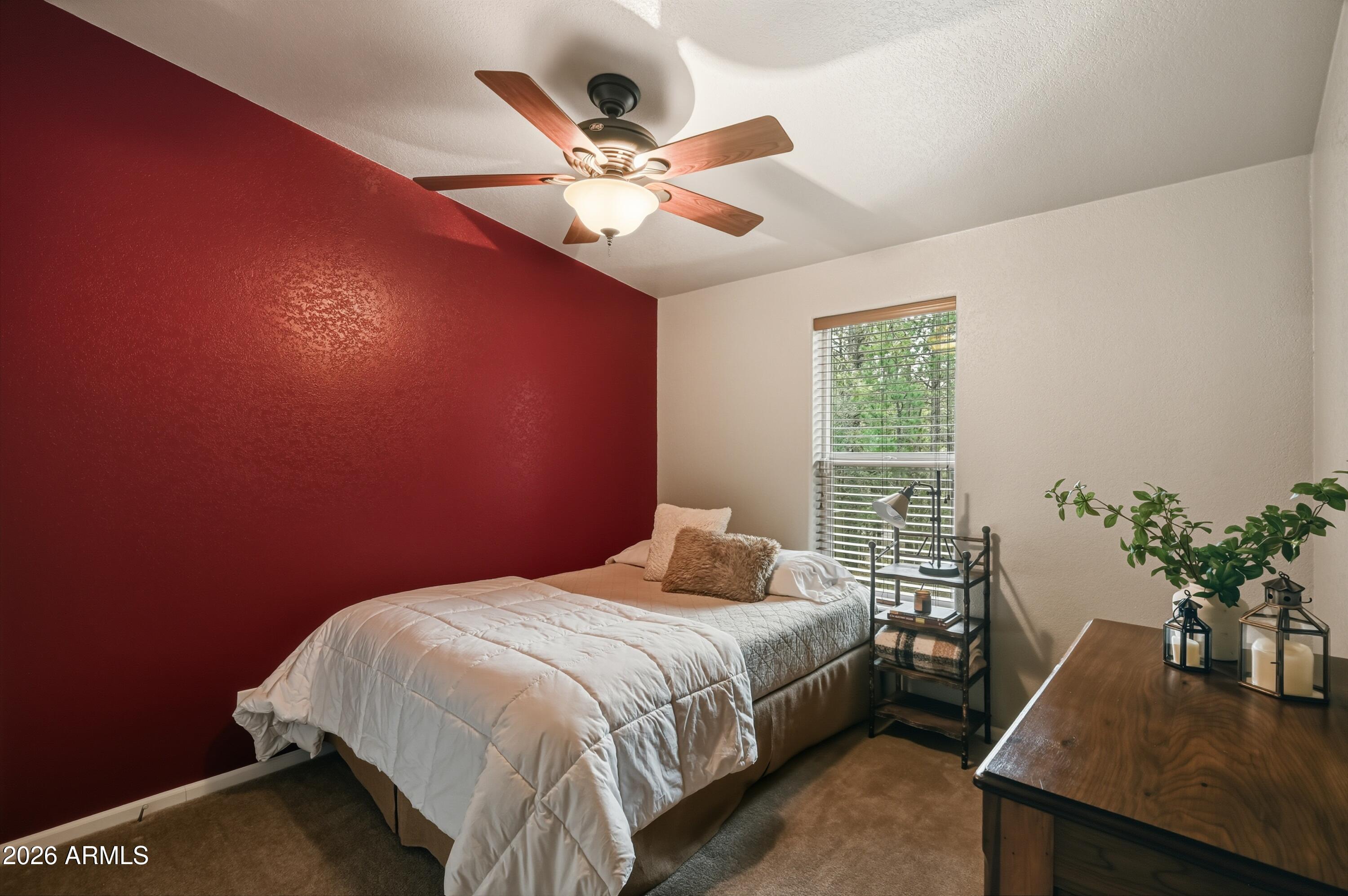 2381 Blue Ridge Drive Happy Jack, AZ 86024 - Photo 22 of 45 a bedroom with a bed and a potted plant