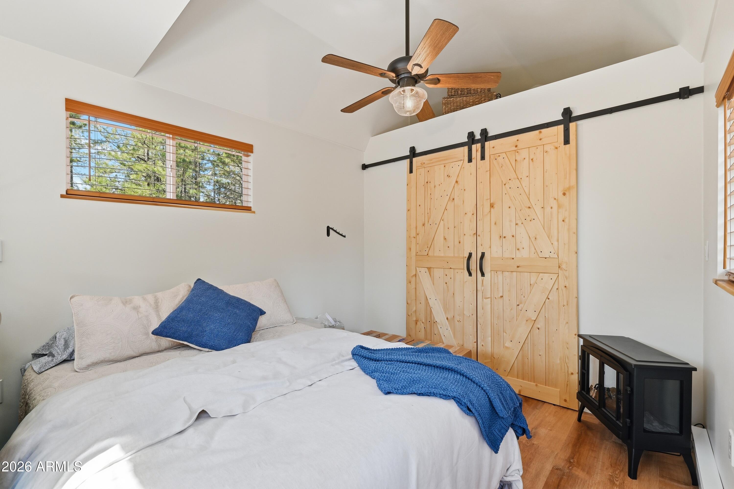 2381 Blue Ridge Drive Happy Jack, AZ 86024 - Photo 27 of 45 a bedroom with a bed and a window