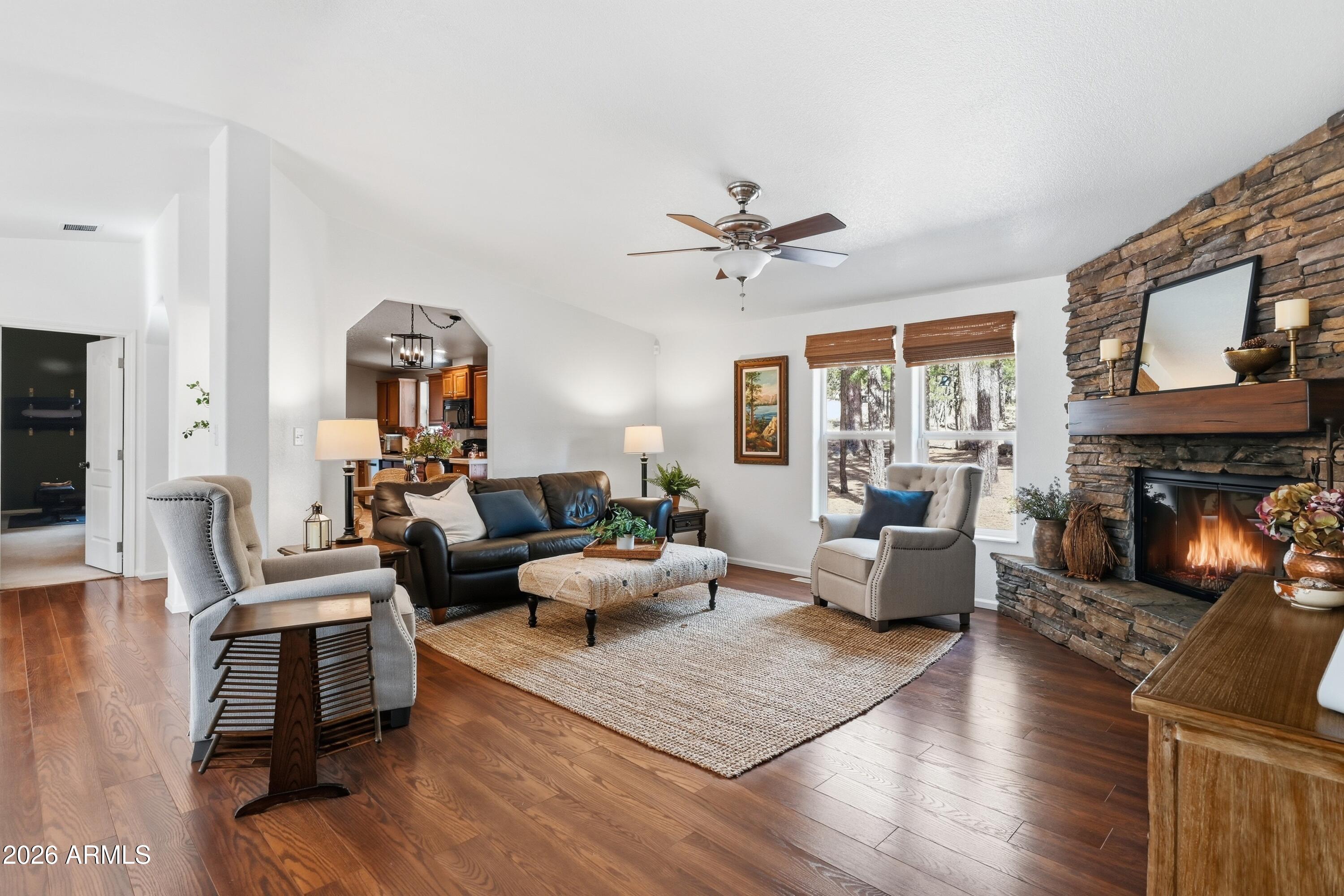 2381 Blue Ridge Drive Happy Jack, AZ 86024 - Photo 5 of 45 a living room with fireplace furniture and a wooden floor