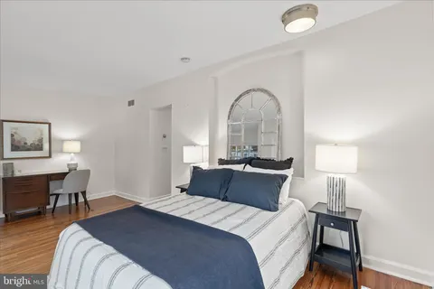 a bedroom with a bed and a table