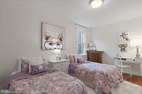 a bedroom with two beds and a table