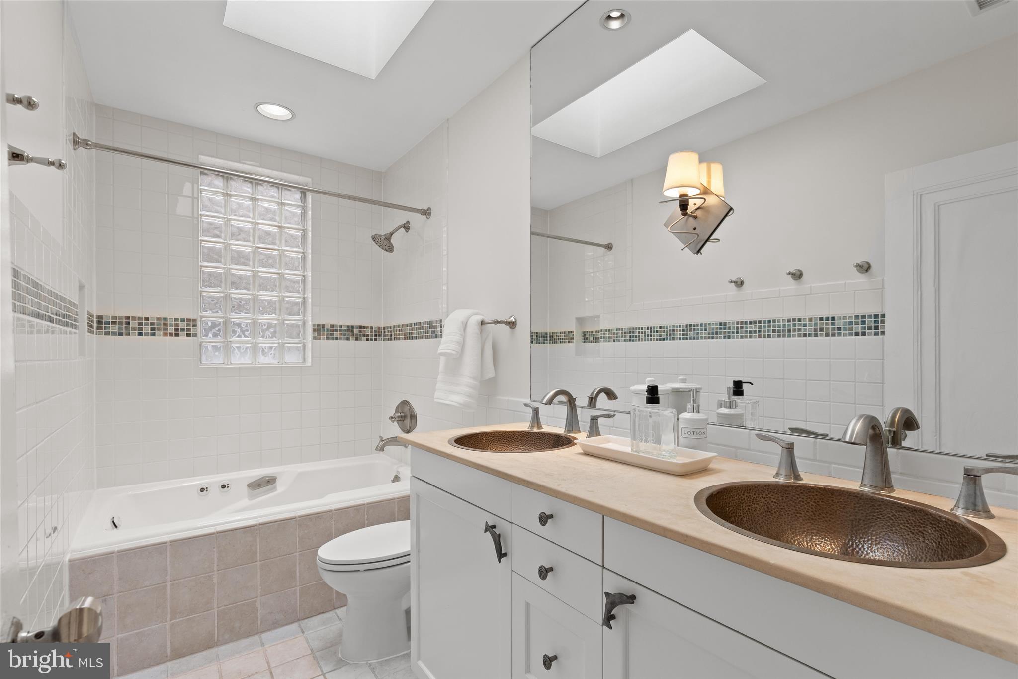 2744 Woodley Place Northwest Washington, DC 20008 - Photo 29 of 41 a bathroom with a granite countertop sink a toilet a mirror and bathtub