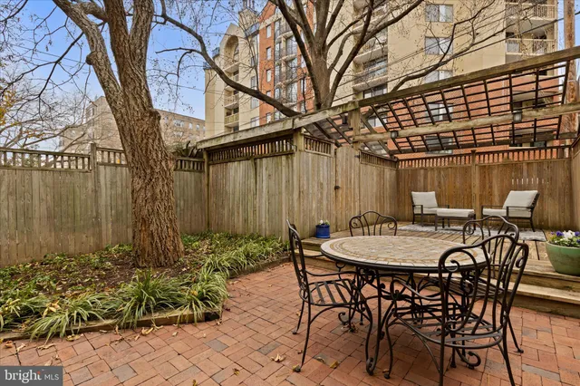 a view of a patio with table and chairs and potted plants