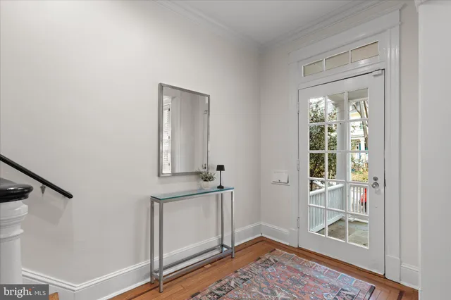 a view of an entryway with wooden floor