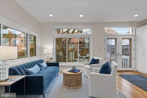 a living room with furniture window and wooden floor