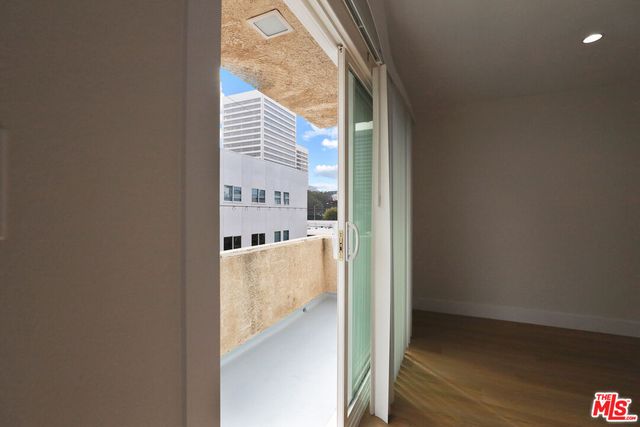 a view of a hallway with a dining table and a refrigerator