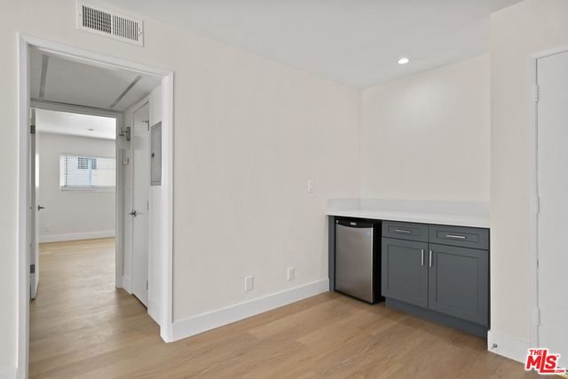 an empty room with wooden floor and closet