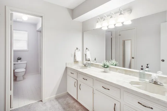 a bathroom with a double vanity sink and a mirror