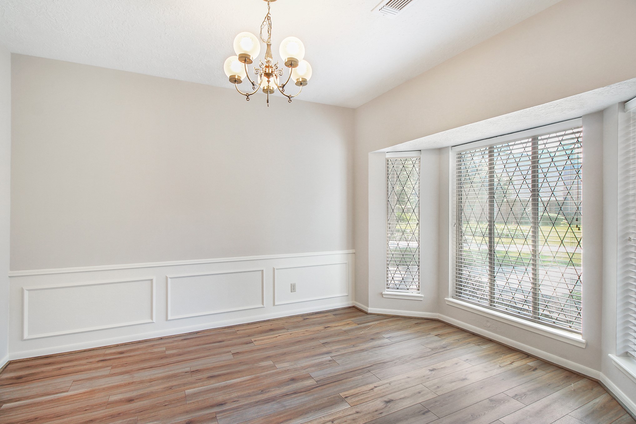 5402 Summerfield Lane Spring, TX 77379 - Photo 5 of 32 a view of an empty room with wooden floor and a window