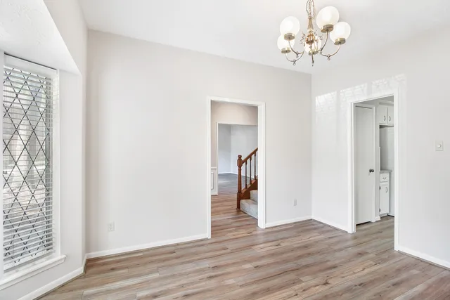 a view of a chandelier in a room with wooden floor