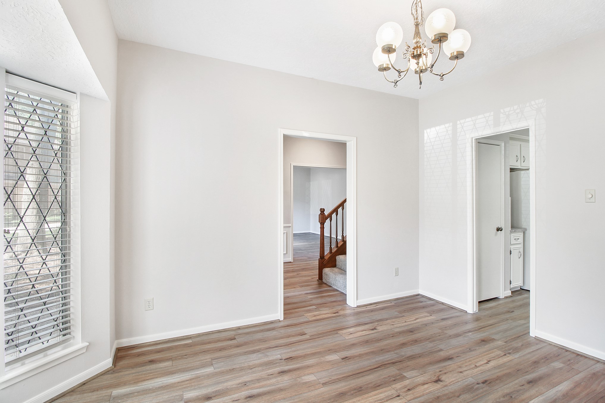 5402 Summerfield Lane Spring, TX 77379 - Photo 6 of 32 a view of a chandelier in a room with wooden floor