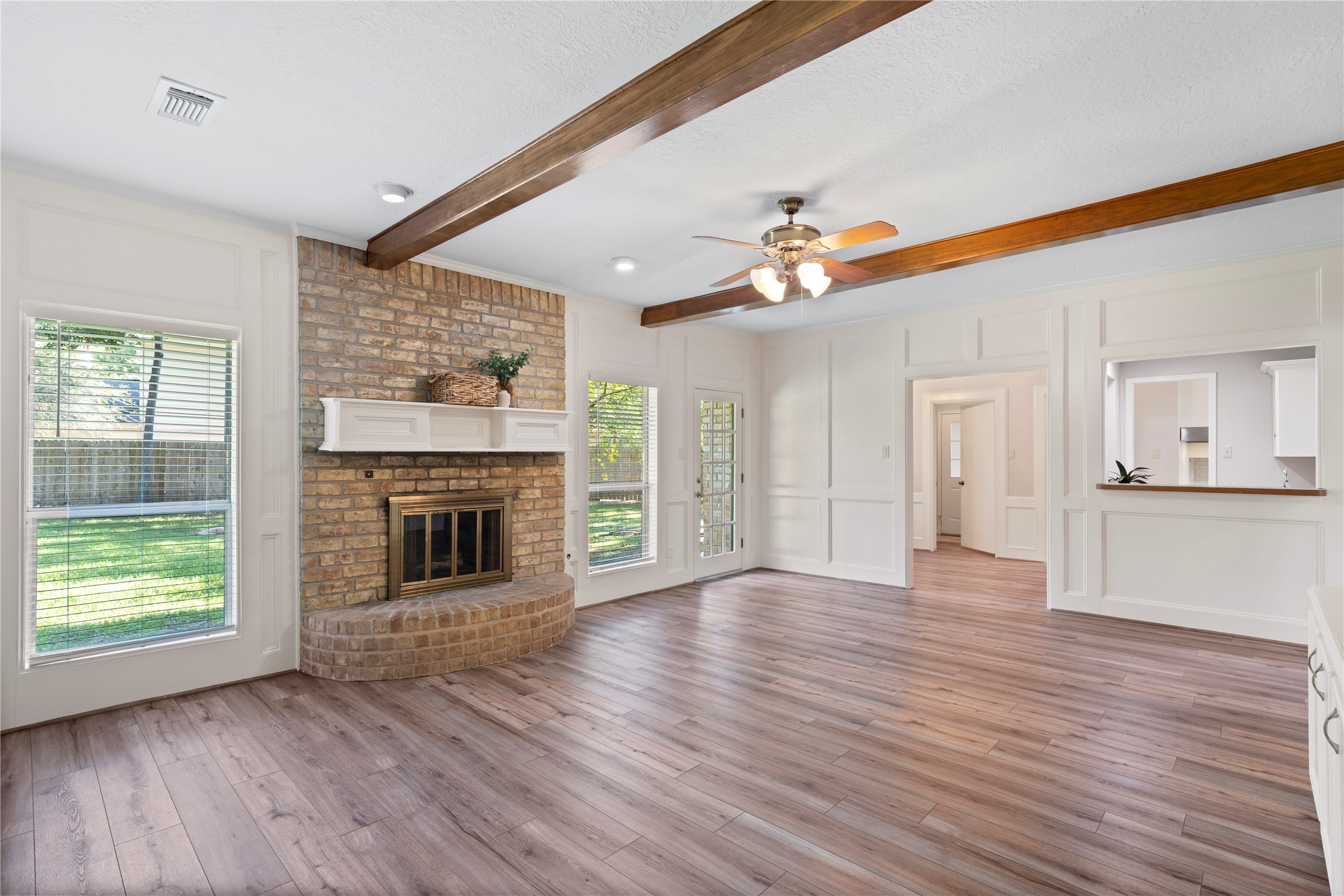 5402 Summerfield Lane Spring, TX 77379 - Photo 7 of 32 an empty room with wooden floor a fireplace and windows