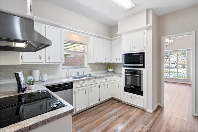 a kitchen with a sink stove and microwave