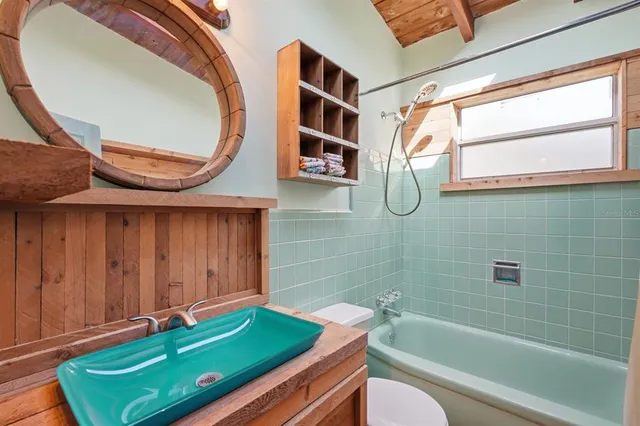 a bedroom with a bed couch and window