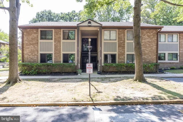 front view of a brick house with a yard
