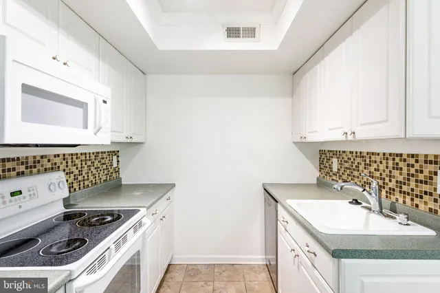 a kitchen that has a sink and a stove