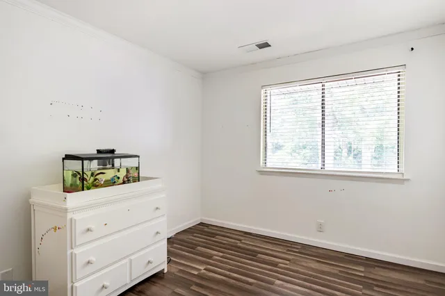 a room with a bed and a dresser