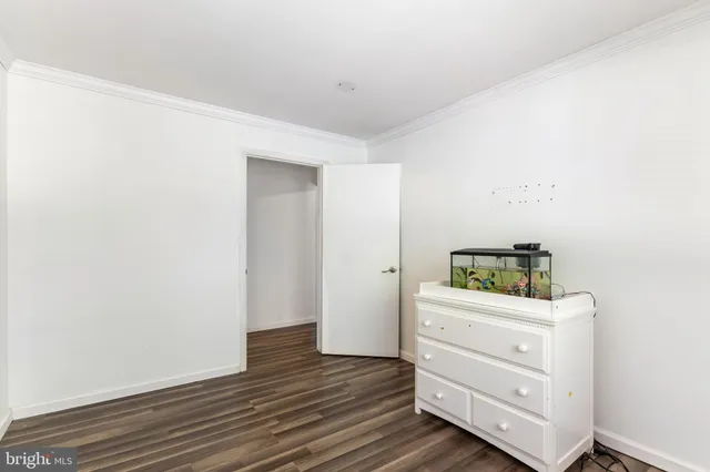 a room with a dresser and wooden floor