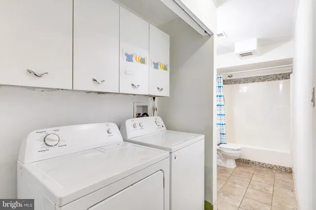 a view of storage and utility room with washer and dryer