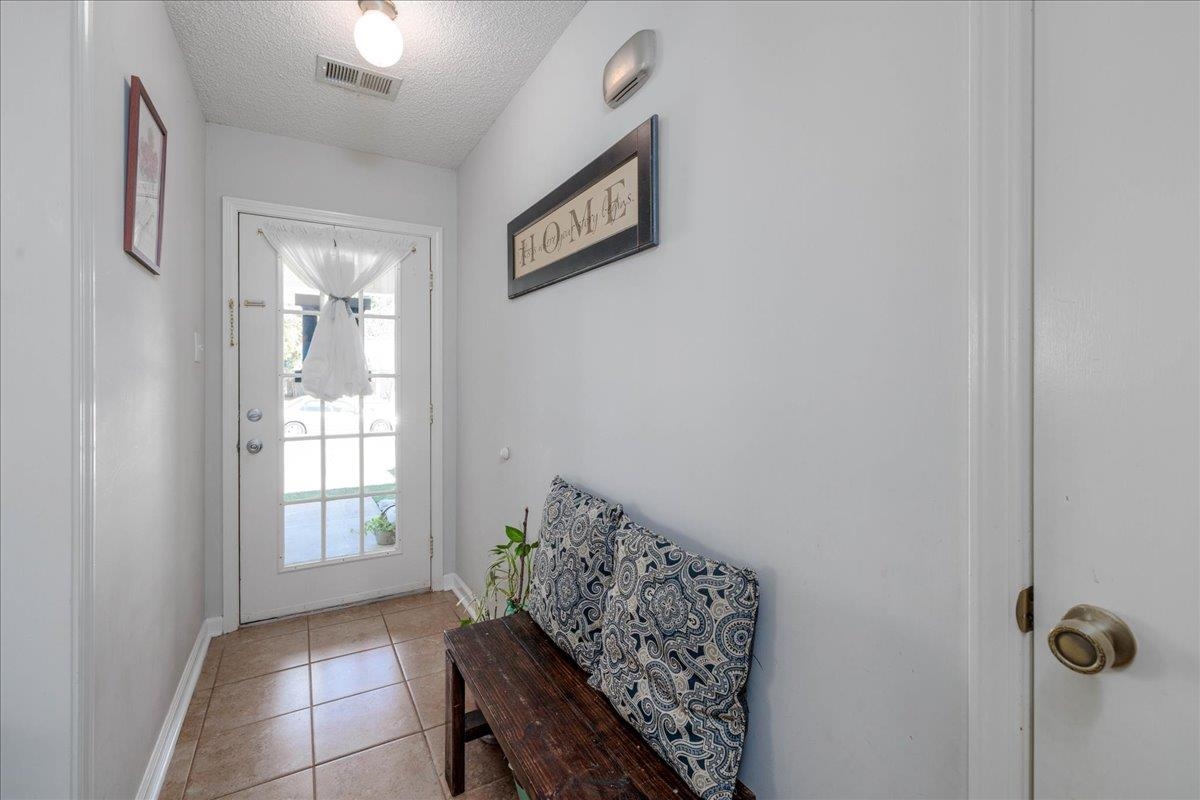 4357 Water Briar Road Millington, TN 38053 - Photo 13 of 29 Doorway to outside featuring light tile patterned floors and a textured ceiling