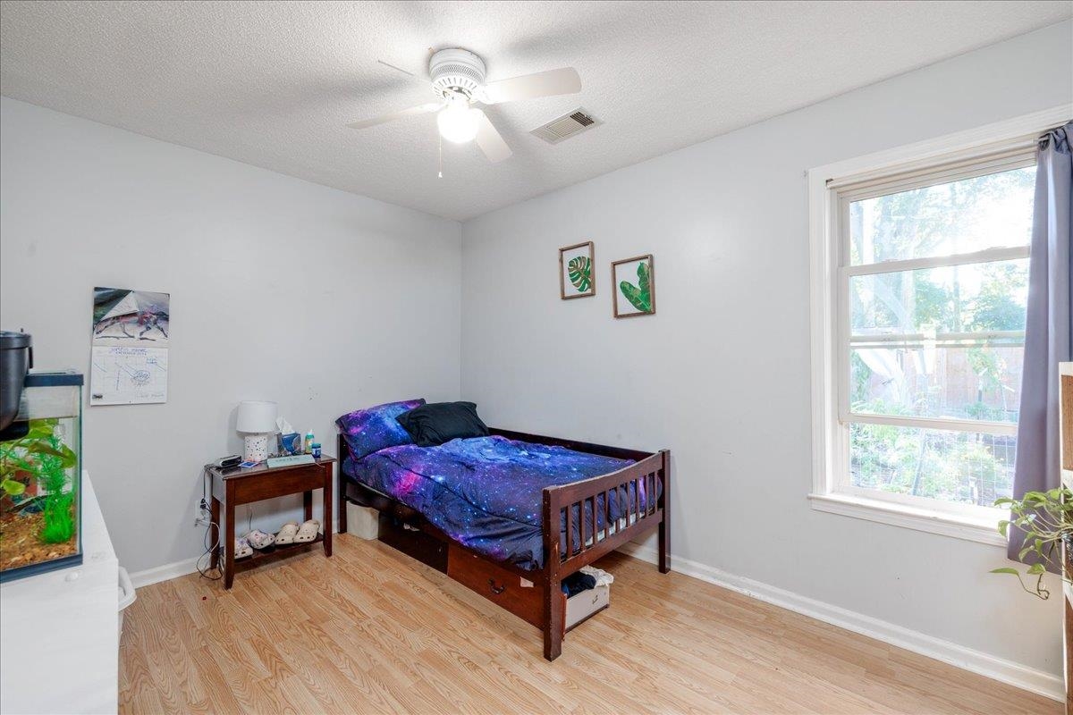 4357 Water Briar Road Millington, TN 38053 - Photo 23 of 29 Bedroom with multiple windows, a textured ceiling, light wood-type flooring, and ceiling fan