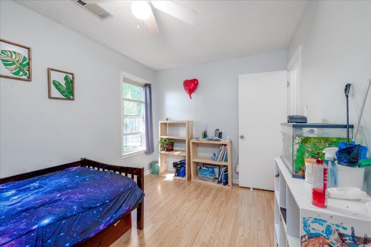 4357 Water Briar Road Millington, TN 38053 - Photo 24 of 29 Bedroom with ceiling fan, a textured ceiling, and light hardwood / wood-style flooring
