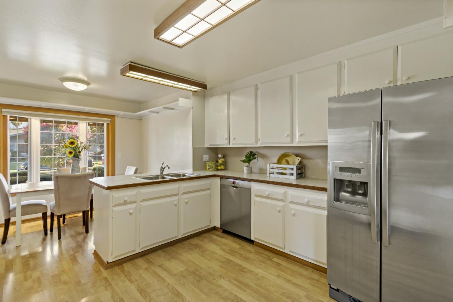 1287 Peralta Drive San Jose, CA 95120 - Photo 24 of 38 a kitchen with stainless steel appliances granite countertop a refrigerator a sink a stove and white cabinets