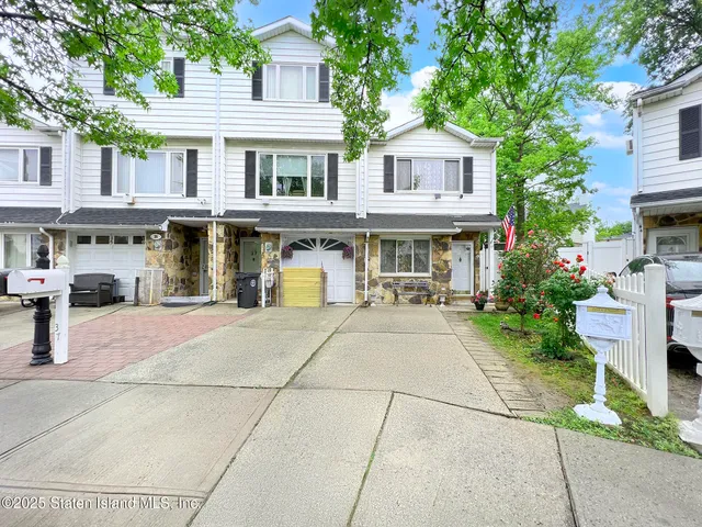 a view of a building with a garden and pathway