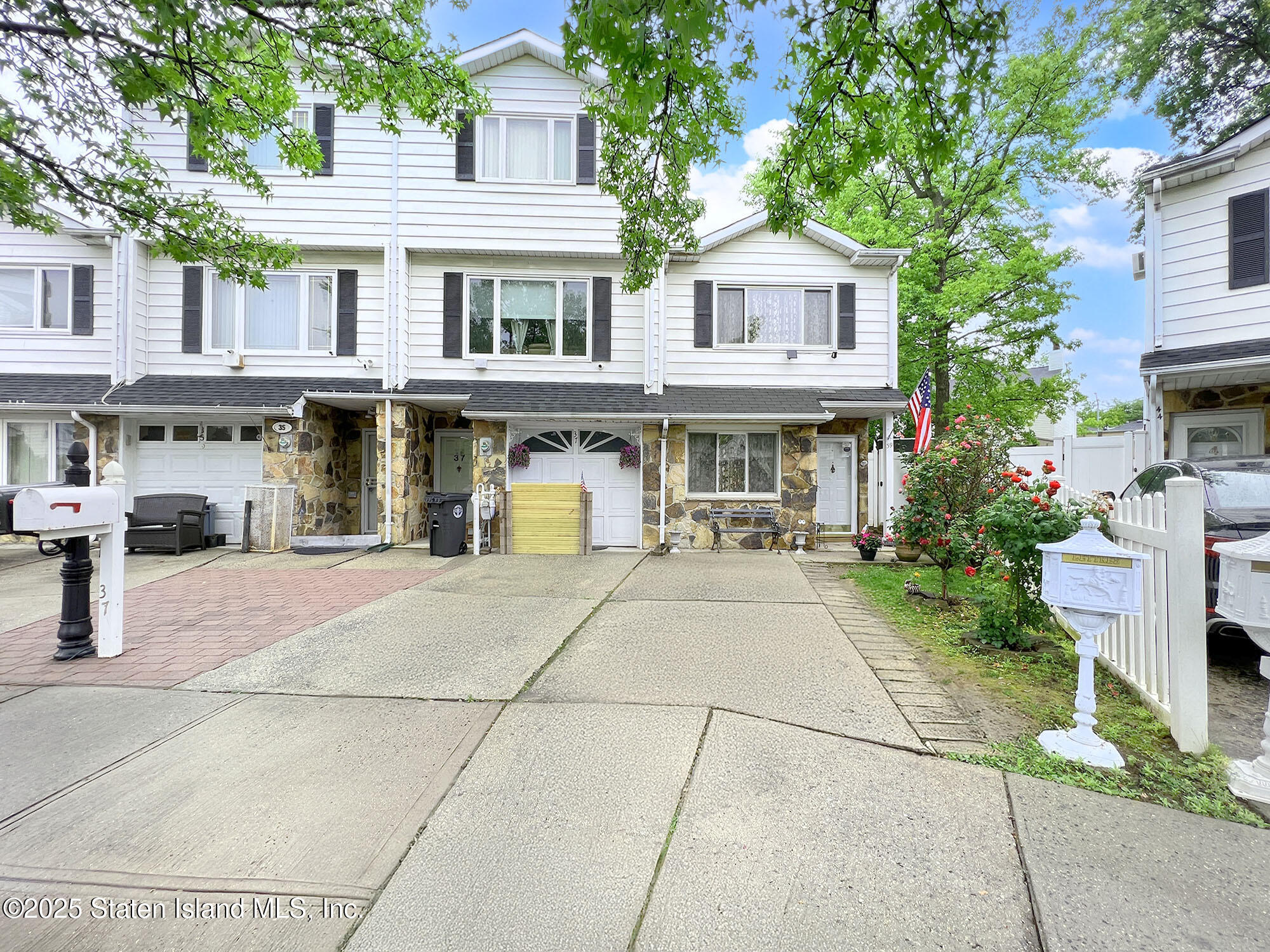 a view of a building with a garden and pathway